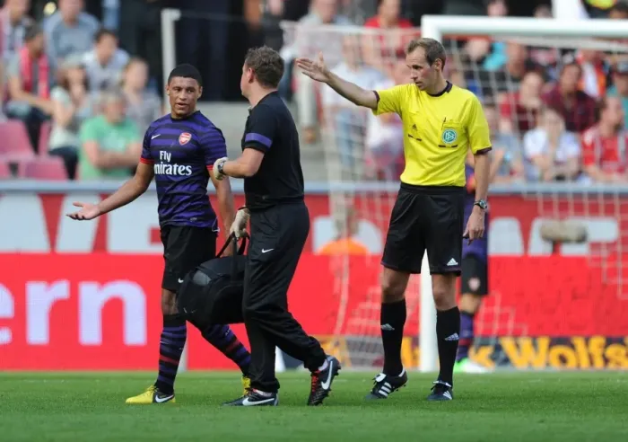 Framed Print : Arsenal's Colin Lewin Tends to Injured Oxlade-Chamberlain in Pre-Season Friendly against Cologne Framed Print : Arsenal's Colin Lewin Tends to Injured Oxlade-Chamberlain in Pre-Season Friendly against Cologne