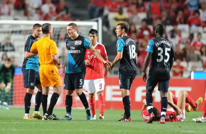 Framed Print : Arsenal's Contentious Encounter with Benfica: Vermaelen, Squillaci, and Lansbury Clash with Referee Gomes Framed Print : Arsenal's Contentious Encounter with Benfica: Vermaelen, Squillaci, and Lansbury Clash with Referee Gomes