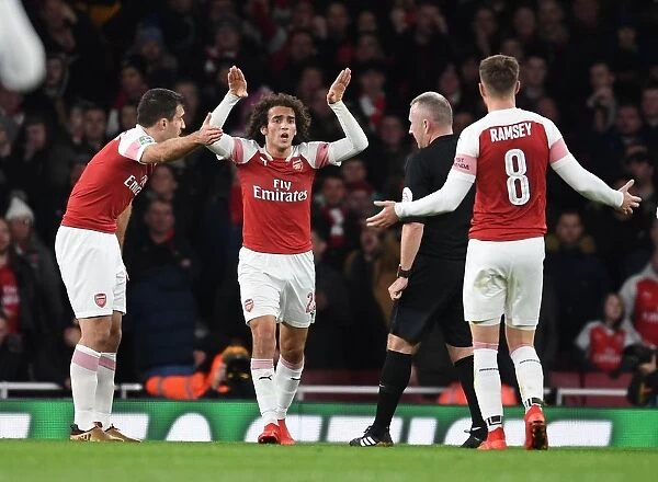 Arsenal's Contentious Trio: Sokratis, Guendouzi, and Ramsey Clash with Referee during Carabao Cup Quarterfinal vs. Tottenham