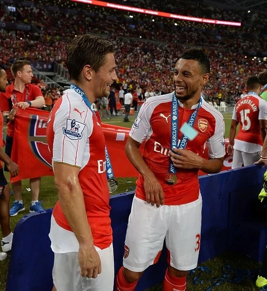 Arsenal's Coquelin and Debuchy: Sharing a Light-Hearted Moment After Asia Trophy Victory Over Everton