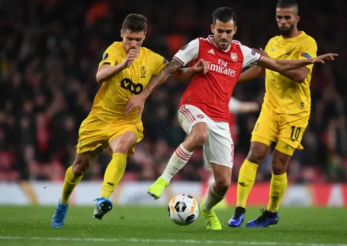 Framed Print : Arsenal's Dani Ceballos Clashes with Standard Liege's Aleksander Boljevic in Europa League Showdown