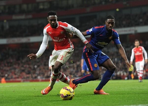 Arsenal's Danny Welbeck Battles Manchester United's Tyler Blackett in Premier League Clash