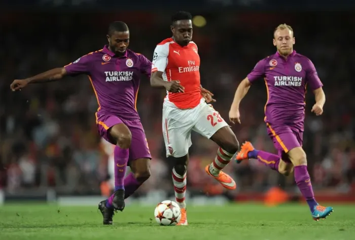 Framed Print : Arsenal's Danny Welbeck Clashes with Galatasaray's Aurelien Chedjou and Semih Kaya in Champions League Showdown Framed Print : Arsenal's Danny Welbeck Clashes with Galatasaray's Aurelien Chedjou and Semih Kaya in Champions League Showdown