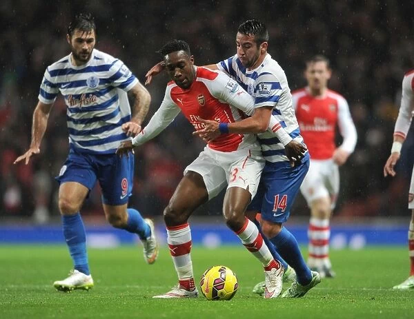Arsenal's Danny Welbeck Clashes with Mauricio Isla of QPR during Premier League Match
