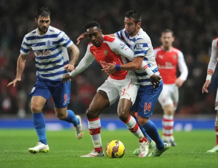 Framed Print : Arsenal's Danny Welbeck Clashes with Mauricio Isla of QPR during Premier League Match