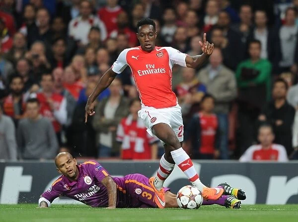 Arsenal's Danny Welbeck Outmaneuvers Galatasaray's Felipe Melo in 2014 Champions League Clash