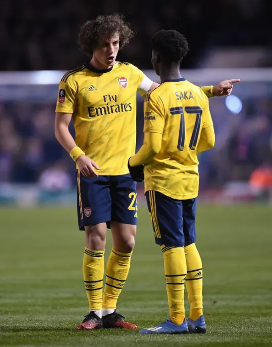 Framed Print : Arsenal's David Luiz Guides Bukayo Saka during FA Cup Clash vs Portsmouth Framed Print : Arsenal's David Luiz Guides Bukayo Saka during FA Cup Clash vs Portsmouth