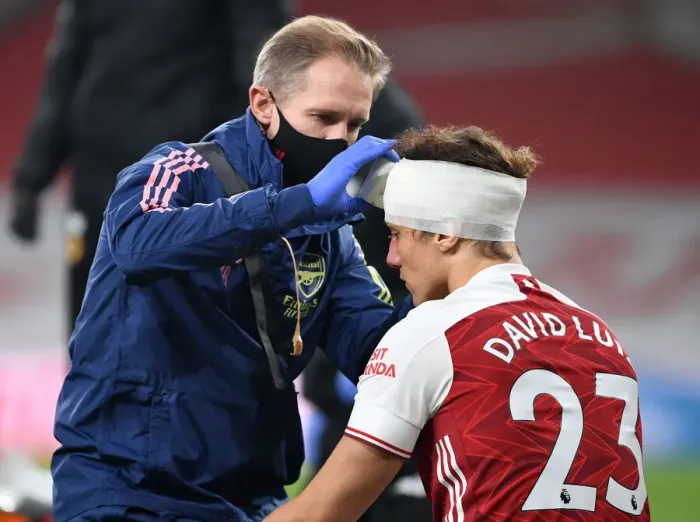 Framed Print : Arsenal's David Luiz Receives Head Injury Treatment Alone at Empty Emirates Stadium (Premier League 2020-21: Arsenal vs. Wolverhampton Wanderers)
