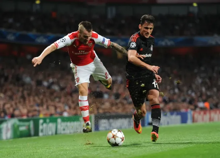 Framed Print : Arsenal's Debuchy Clashes with Besiktas Pektemek in UEFA Champions League Qualifier