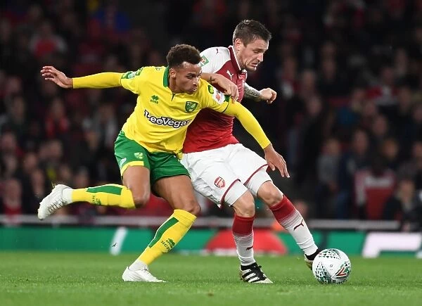 Arsenal's Debuchy Holds Off Norwich's Murphy in Carabao Cup Clash