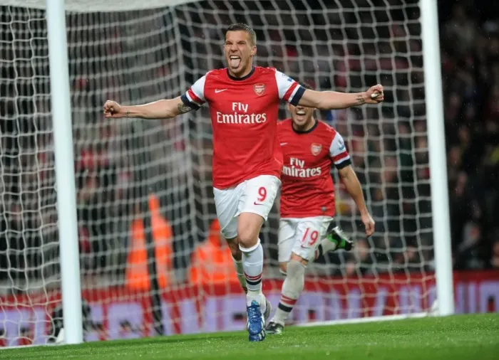 Framed Print : Arsenal's Dominance: Podolski's Brace Secures 4-1 Premier League Victory Over Wigan Athletic