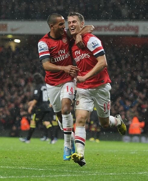 Arsenal's Double Celebration: Ramsey and Walcott Rejoice in Goal Scoring Moment vs. Wigan (2012-13)