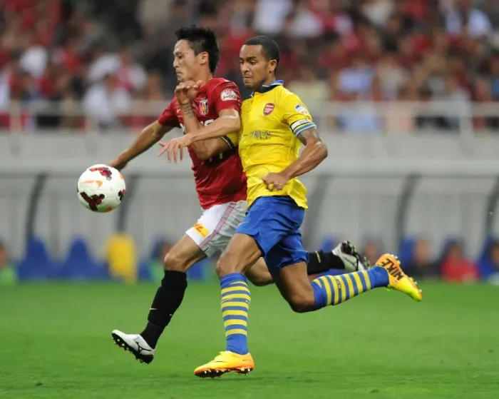Framed Print : Arsenal's East Asian Showdown: Theo Walcott vs. Kunimitsu Sekiguchi