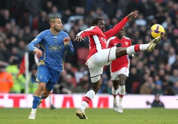 Arsenal's Eboue Clashes with Portsmouth's Belhadj: 1-0 Victory in the Barclays Premier League at Emirates Stadium (December 28, 2008)