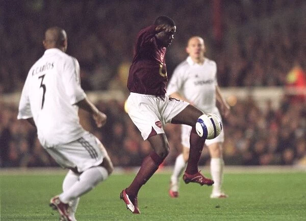 Arsenal's Eboue Stands Strong Against Real Madrid in UEFA Champions League at Highbury, 2006