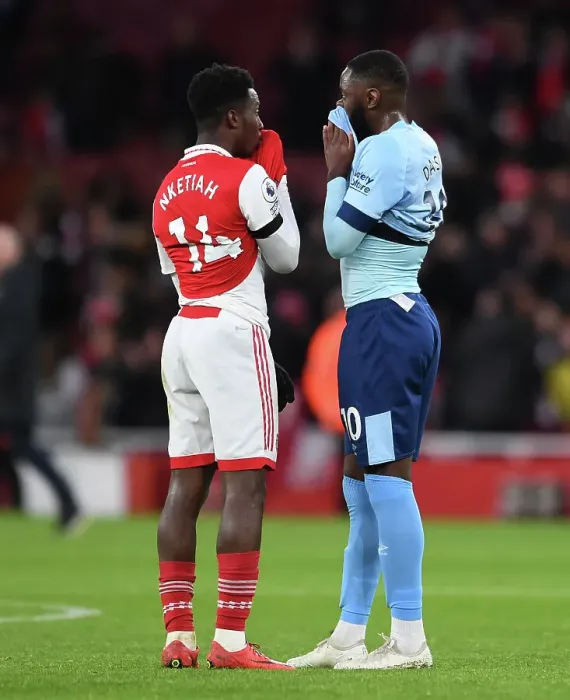 Framed Print : Arsenal's Eddie Nketiah and Brentford's Josh Dasilva Share a Moment After Arsenal FC vs Brentford FC in Premier League Framed Print : Arsenal's Eddie Nketiah and Brentford's Josh Dasilva Share a Moment After Arsenal FC vs Brentford FC in Premier League