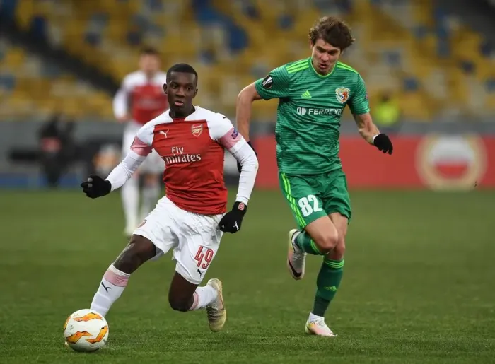 Framed Print : Arsenal's Eddie Nketiah Clashes with Pavlo Rebenok of Vorskla in Europa League Match