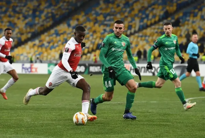 Framed Print : Arsenal's Eddie Nketiah Faces Off Against Vorskla's Ardin Dallku in Europa League Clash Framed Print : Arsenal's Eddie Nketiah Faces Off Against Vorskla's Ardin Dallku in Europa League Clash