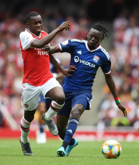 Framed Print : Arsenal's Eddie Nketiah Outmaneuvers Lyon's Bertrand Traore in Emirates Cup Clash Framed Print : Arsenal's Eddie Nketiah Outmaneuvers Lyon's Bertrand Traore in Emirates Cup Clash