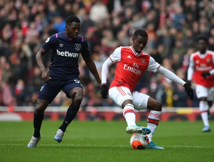 Framed Print : Arsenal's Eddie Nketiah Shields Off Against West Ham's Jeremy Ngakia in Premier League Clash Framed Print : Arsenal's Eddie Nketiah Shields Off Against West Ham's Jeremy Ngakia in Premier League Clash