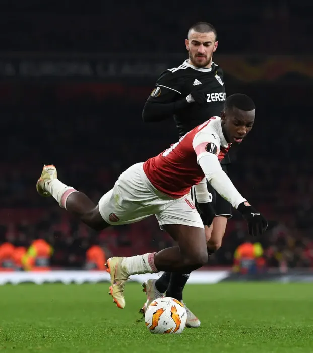 Framed Print : Arsenal's Eddie Nketiah Tripped by Qarabag's Maksin Medvedev during Europa League Clash Framed Print : Arsenal's Eddie Nketiah Tripped by Qarabag's Maksin Medvedev during Europa League Clash