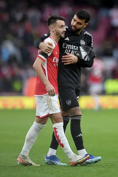 Framed Print : Arsenal's Embrace: Fabio Vieira and David Raya Celebrate Victory Over Sheffield United (2023-24)