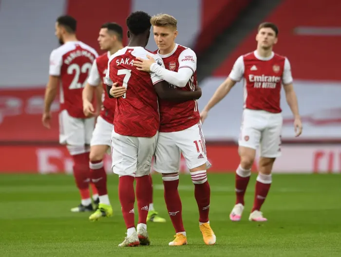 Framed Print : Arsenal's Embrace: Saka and Odegaard Unite Amidst Empty Emirates Stadium (Arsenal v Manchester City, 2021) Framed Print : Arsenal's Embrace: Saka and Odegaard Unite Amidst Empty Emirates Stadium (Arsenal v Manchester City, 2021)