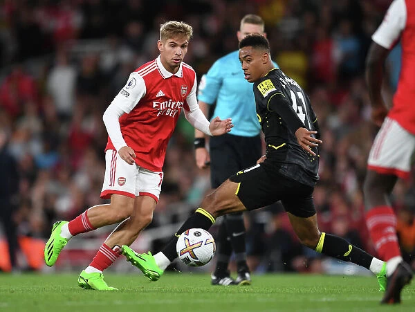 Arsenal's Emile Smith Rowe Fends Off Aston Villa's Jacob Ramsey During Premier League Clash at Emirates Stadium