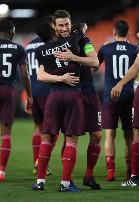Framed Print : Arsenal's Emotional Reunion: Lacazette and Koscielny Hug After Europa League Semifinal Victory Framed Print : Arsenal's Emotional Reunion: Lacazette and Koscielny Hug After Europa League Semifinal Victory