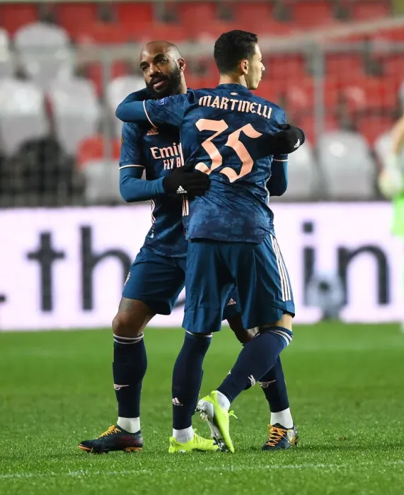 Framed Print : Arsenal's Emotional Reunion: Martinelli and Lacazette Hug It Out in Empty Eden Arena during Europa League Quarterfinal
