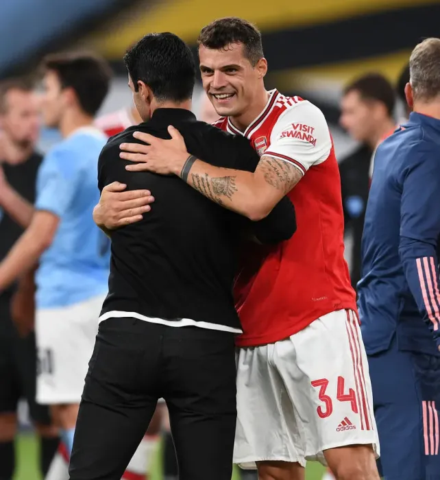 Framed Print : Arsenal's FA Cup Semi-Final Triumph: Mikel Arteta and Granit Xhaka Embrace Victory over Manchester City