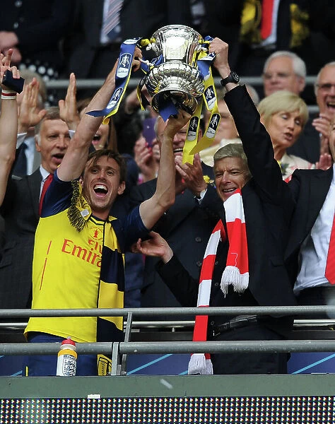 Arsenal's FA Cup Victory: Arsene Wenger and Nacho Monreal Celebrate with the Trophy (2015)