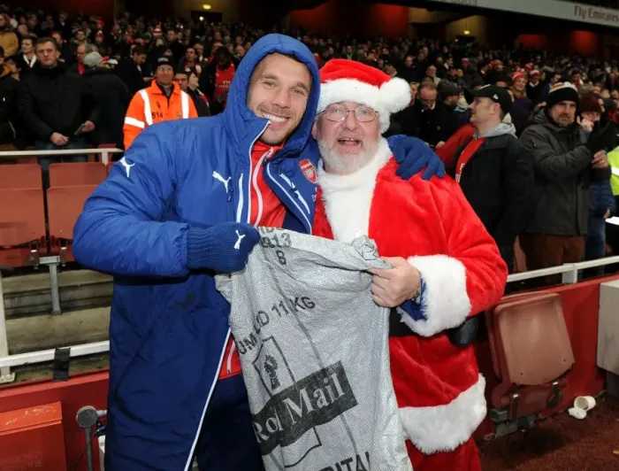 Framed Print : Arsenal's Festive Surprise: Lukas Podolski and the Arsenal Chef Dressed as Father Christmas Ahead of Arsenal v Newcastle United Match