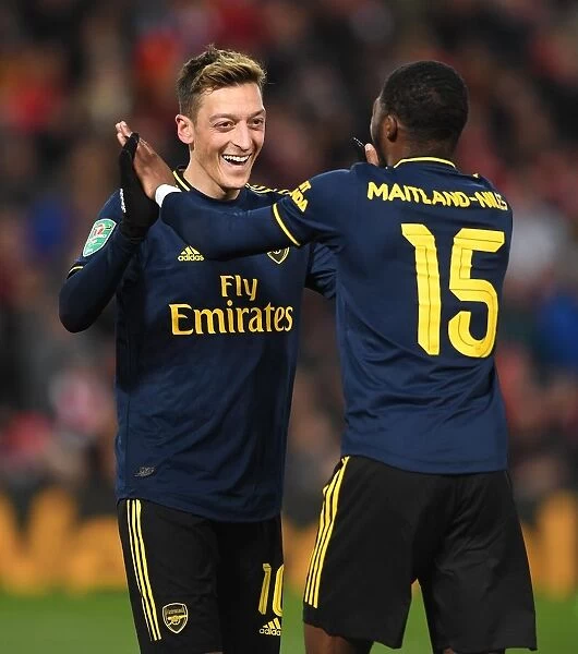 Arsenal's Four-Goal Rampage: Ozil and Maitland-Niles Celebrate at Anfield