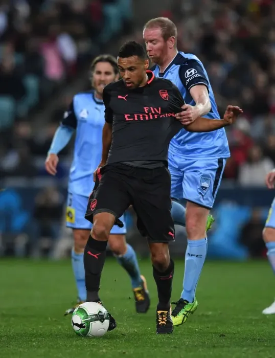 Framed Print : Arsenal's Francis Coquelin Clashes with Sydney FC's David Carney in Pre-Season Friendly