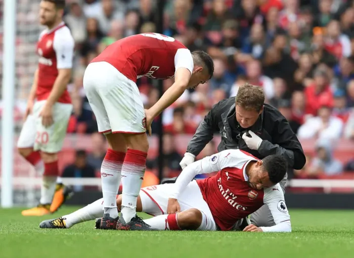 Framed Print : Arsenal's Francis Coquelin Receives Treatment from Physio Colin Lewin vs AFC Bournemouth