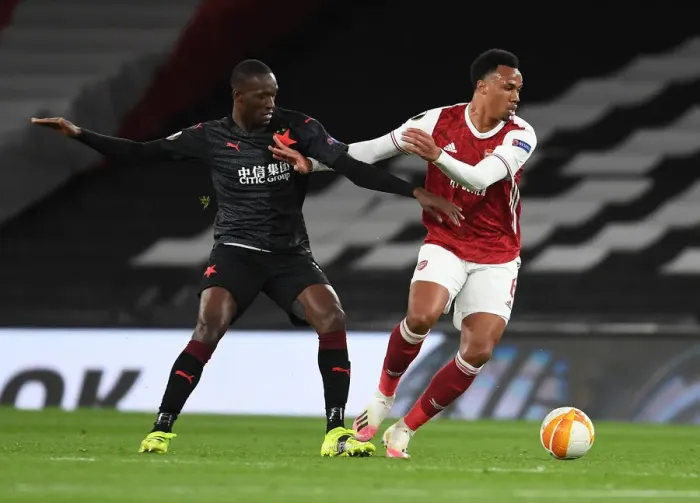 Framed Print : Arsenal's Gabriel Breaks Past Slavia Praha's Sima in Empty Europa League Quarterfinal Framed Print : Arsenal's Gabriel Breaks Past Slavia Praha's Sima in Empty Europa League Quarterfinal