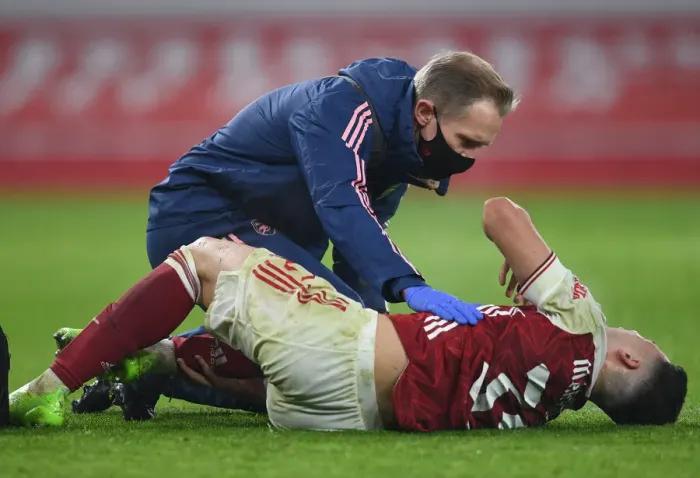 Framed Print : Arsenal's Gabriel Martinelli Suffers Injury in Empty Emirates Stadium During Carabao Cup Quarterfinals Against Manchester City