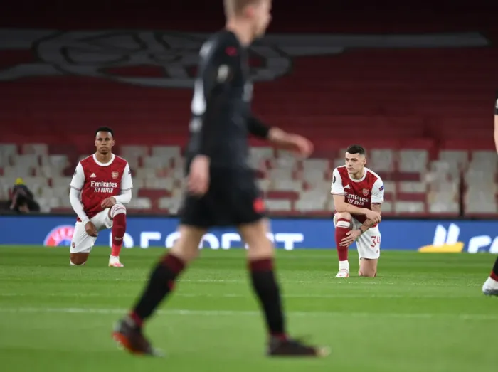 Framed Print : Arsenal's Gabriel and Xhaka Kneel Before Empty Emirates Stadium in Europa League Quarterfinal vs Slavia Praha