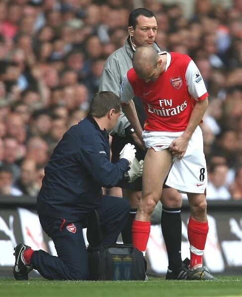 Arsenal's Gary Lewin Tends to Freddie Ljungberg: FA Premiership Clash at White Hart Lane, 2007