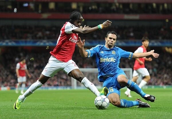 Arsenal's Gervinho Clashes with Marseille's Jeremy Morel in UEFA Champions League Showdown