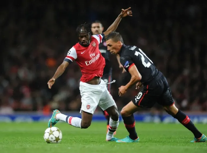 Framed Print : Arsenal's Gervinho Clashes with Olympiacos Jose Holebas in Champions League Showdown