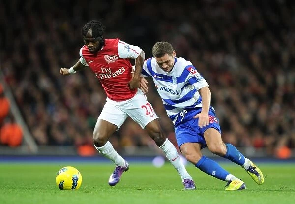 Arsenal's Gervinho Clashes with QPR's Luke Young during Premier League Match