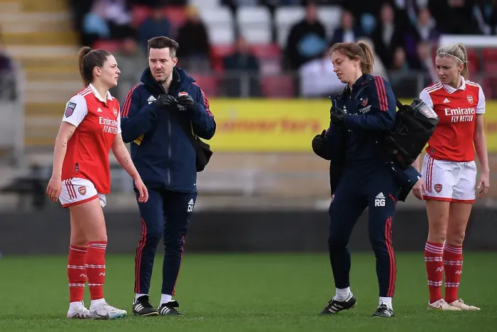 Framed Print : Arsenal's Gio Queiroz Receives Medical Attention During Tottenham vs Arsenal Women's Super League Clash