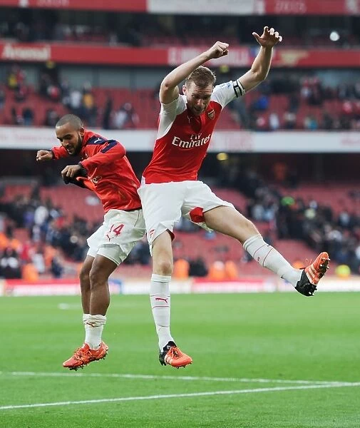 Arsenal's Glory: Theo Walcott and Per Mertesacker Celebrate Hard-Fought Victory Over Manchester United (2015 / 16 Premier League)