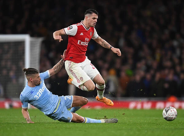 Arsenal's Granit Xhaka Battles Past Leeds Kalvin Phillips in FA Cup Clash