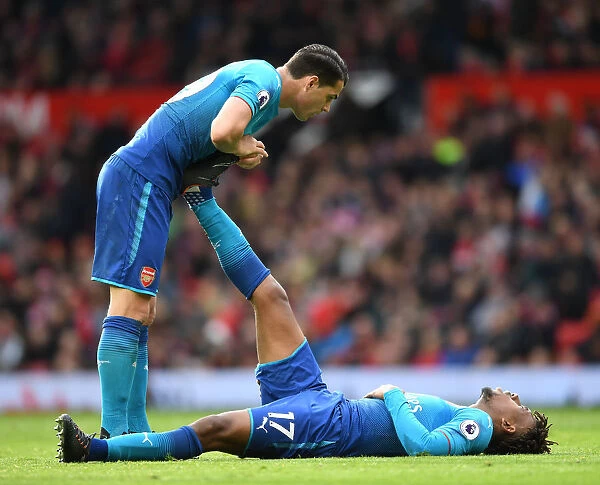 Arsenal's Granit Xhaka Consoles Injured Teammate Alex Iwobi During Manchester United Clash