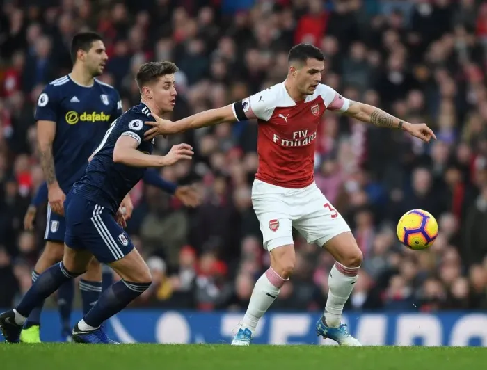 Framed Print : Arsenal's Granit Xhaka Fends Off Fulham's Tom Cairney in Premier League Clash