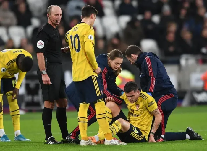 Framed Print : Arsenal's Granit Xhaka Receives Treatment During West Ham Clash (2019-20)