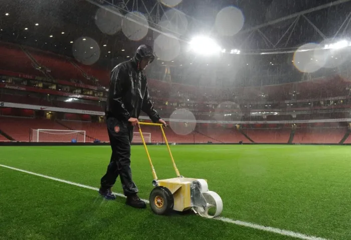 Framed Print : Arsenal's Groundsman Braves the Rain to Prepare for Arsenal v Chelsea Showdown Framed Print : Arsenal's Groundsman Braves the Rain to Prepare for Arsenal v Chelsea Showdown